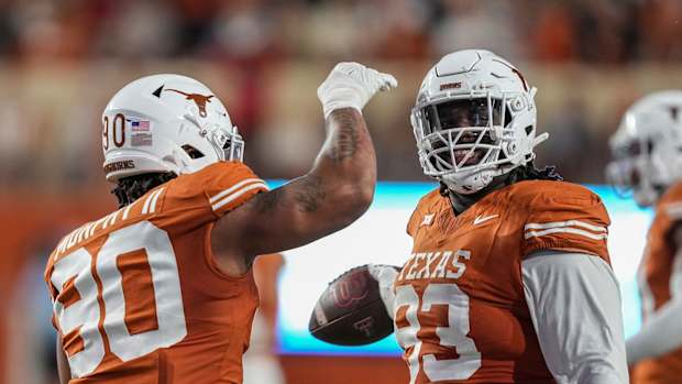 Texas Longhorns DT Byron Murphy celebrates with T'Vondre Sweat